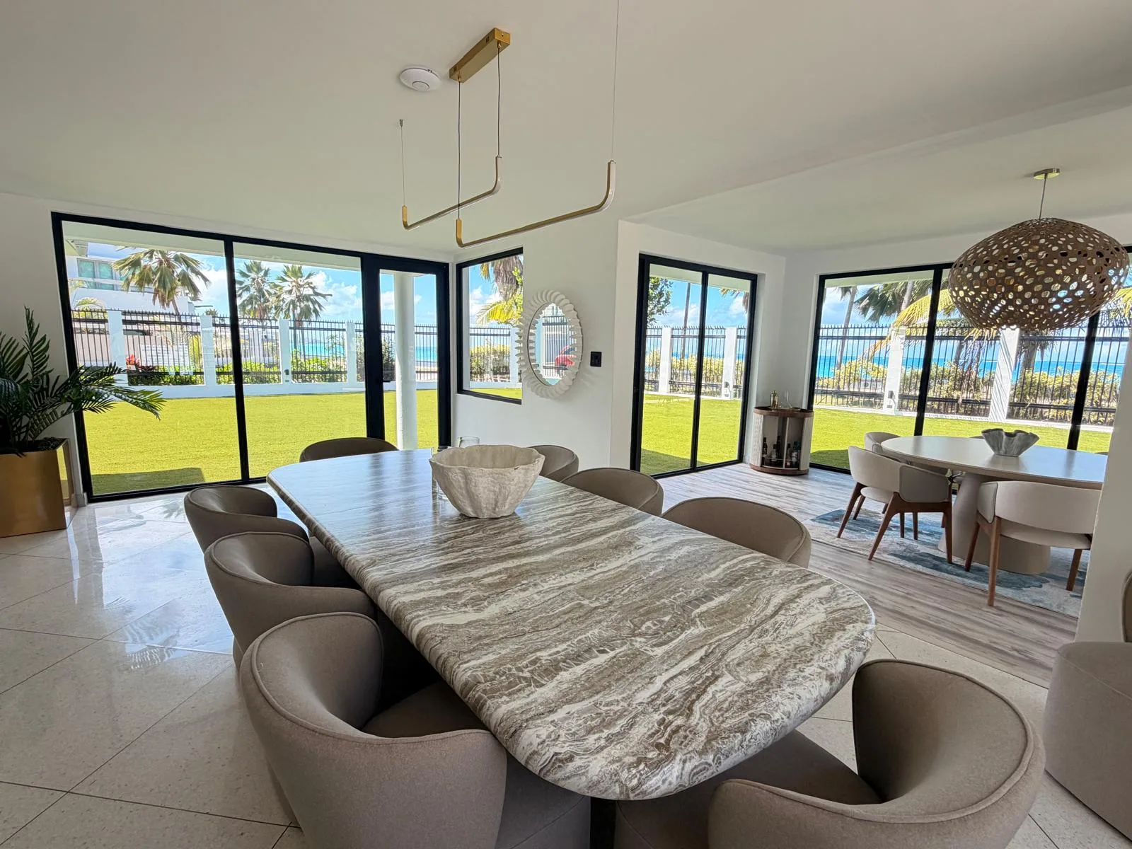 The long marble table with an ocean view, set for a working session