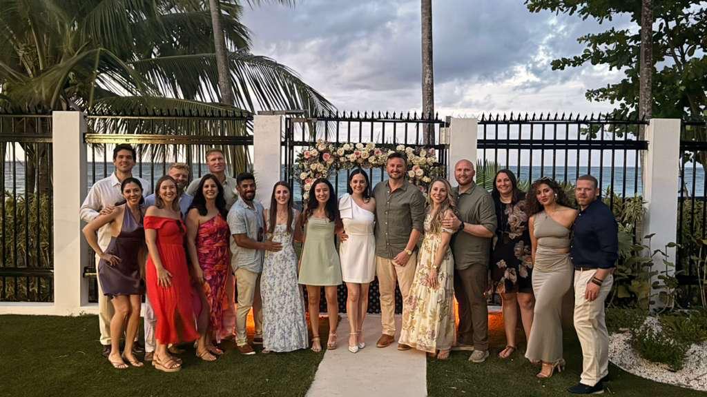 Wedding celebration at Villa Azure — guests gathered under the floral ceremony arch